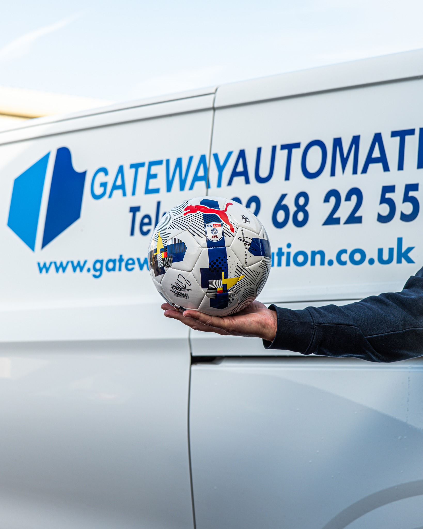 Lincoln City Fc signed football in front of a Gateway Automation van.